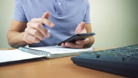 Close up of hands typing on smartphone in office interior Stock Footage 84267177