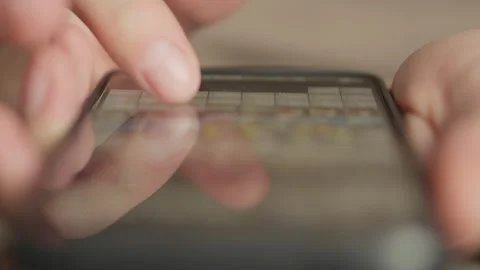 Close up of hands typing on a smartphone screen, focusing on fingers interacting Stock Footage 341032400