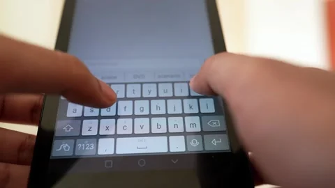 Close-up of hands typing on a smartphone touchscreen keyboard Stock Footage 317737532