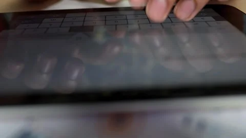 Close-up of hands typing on a tablet keyboard Stock Footage 320724576