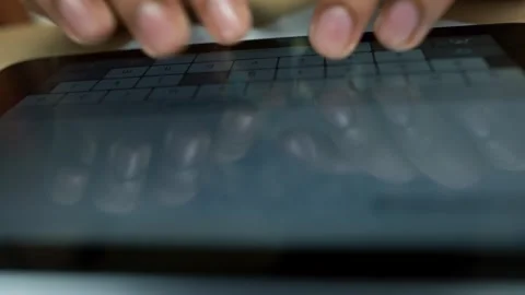 Close-up of hands typing on a tablet keyboard Stock Footage 320724648