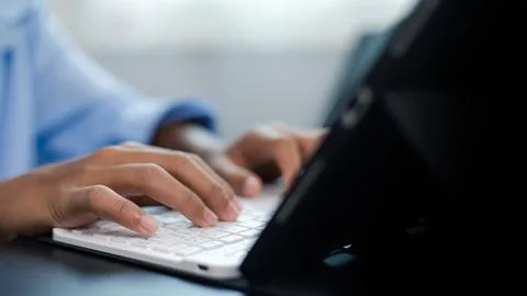 Close Up Hands Typing on Tablet Keyboard for Remote Work and Online Learning Stock Photos