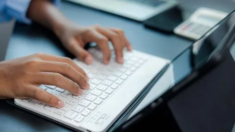 Close Up Hands Typing on Tablet Keyboard for Business and Online Work Stock Photos