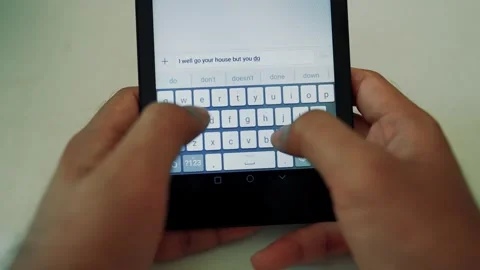 Close-up of hands typing on a tablet with an on-screen keyboard Stock Footage 318056822