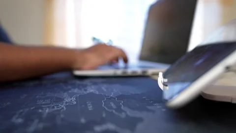 Close-up of hands typing on a tablet with a stand on a map Stock Footage 317737454