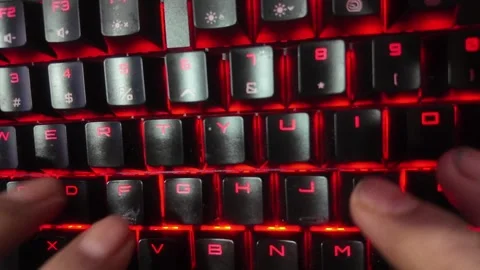 Close-up of hands typing on a vibrant RGB mechanical gaming keyboard,  focu.. Stock Footage 328340558