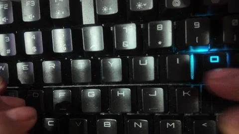 Close-up of hands typing on a vibrant RGB mechanical gaming keyboard,  focu.. Stock Footage 328340577