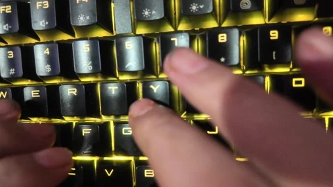 Close-up of hands typing on a vibrant RGB mechanical gaming keyboard,  focu.. Stock Footage 328340578