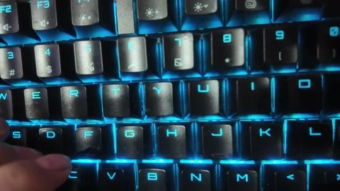 Close-up of hands typing on a vibrant RGB mechanical gaming keyboard,  focu.. Stock Footage 328340579