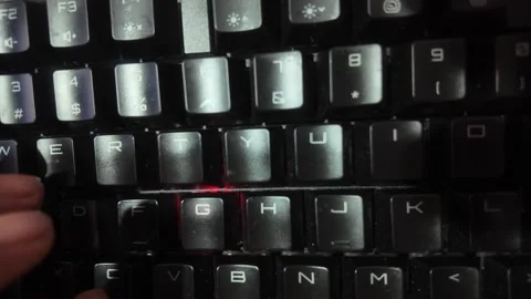 Close-up of hands typing on a vibrant RGB mechanical gaming keyboard,  focu.. Stock Footage 329139627