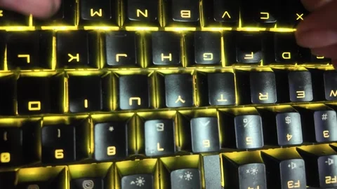 Close-up of hands typing on a vibrant RGB mechanical gaming keyboard,  focu.. Stock Footage 329139639