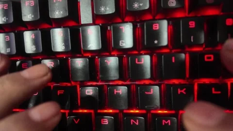 Close-up of hands typing on a vibrant RGB mechanical gaming keyboard,  focu.. Stock Footage 329139660