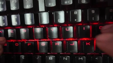 Close-up of hands typing on a vibrant RGB mechanical gaming keyboard,  focu.. Stock Footage 329139677