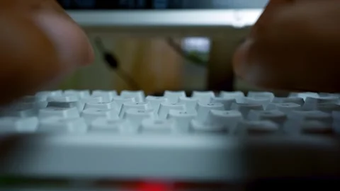 Close-up of hands typing on a white keyboard on a wooden desk Vídeo Stock 315981267