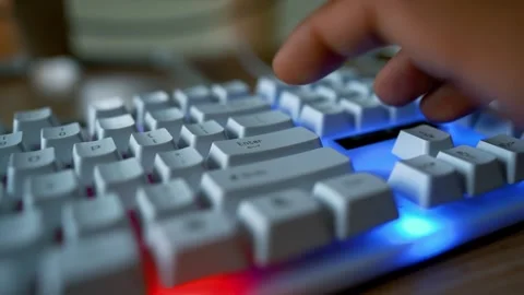 Close-up of hands typing on a white keyboard on a wooden desk Stock-Footage 315981280