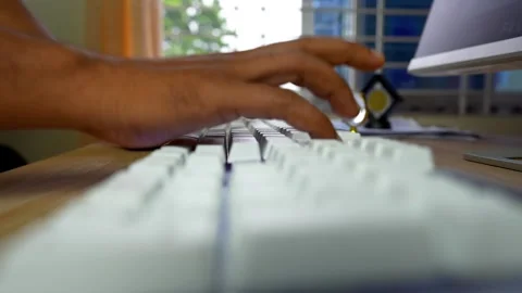 Close-up of hands typing on a white keyboard in an office setting Stock Footage 315981288