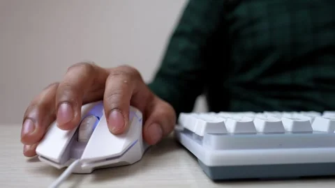 Close-up of hands typing on a white keyboard, wearing a green plaid shirt Stock Footage 320724844