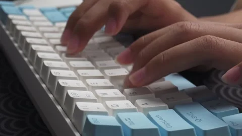 Close up of hands typing on wireless keyboard on desk 库存影片 276716893