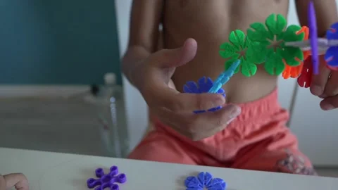 Close up on hands of unknown child play with Interlocking plastic toys 스톡 동영상 247022205