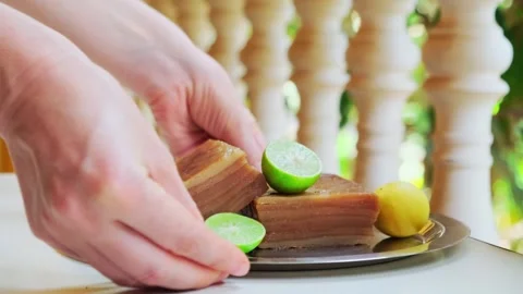 Close-up hands of unknown woman put a plate with goan pie on the table. Stock Footage 245126121