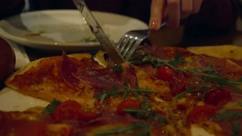 Close up of hands of unknown woman slice piece of pizza cut in the plate eati Stock Footage 221456359