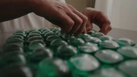 Close-up hands of unrecognizable arranging and sorting laundry detergent Stock Footage 312352005