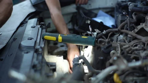 Close-up hands of unrecognizable auto mechanics examining car engine, looking Stock Footage 161956323