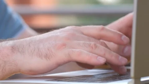 Close-up of hands of unrecognizable businessman typing on laptop keyboard while Stock Footage 242470155