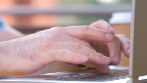 Close-up of hands of unrecognizable businessman typing on laptop keyboard while Stock Footage 242795000