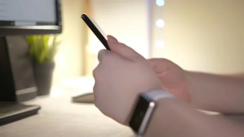 Close-up hands of unrecognizable businessman using mobile phone sitting at desk Stock Footage 236456244