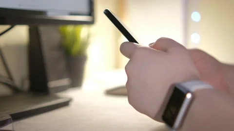 Close-up hands of unrecognizable businessman using mobile phone sitting at desk Stock Footage 236629223
