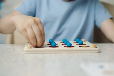 Close-up of the hands of an unrecognizable child playing a game for the devel Stock Photos