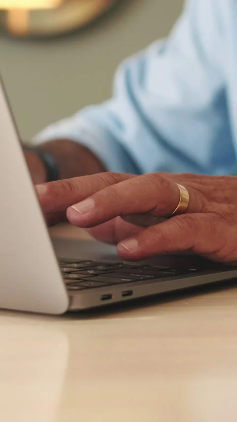 Close-up of hands of an unrecognizable elderly man working on laptop Stock Footage 252031035
