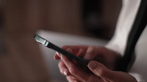 Close-up hands of unrecognizable female hands holding using smartphone. Closeup Video stock 261989082