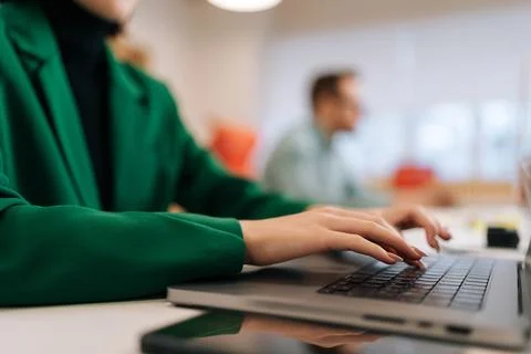 Close-up hands of unrecognizable female programmer typing program code on laptop 库存照片
