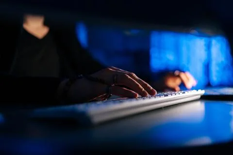 Close-up hands of unrecognizable hacker man working typing on keyboard laptop Stock Photos