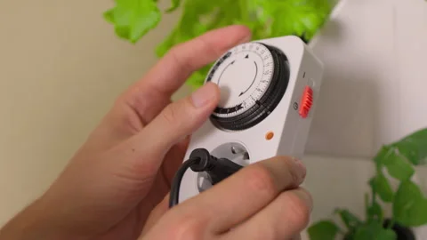 Close-up hands of unrecognizable man adjusting settings on electrical timer Stock Footage 317395778