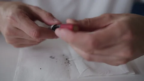 Close-up hands of unrecognizable man cleaning electronic cigarette device during Stock Footage 318013984