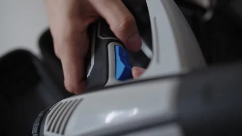 Close-up hands of unrecognizable man holding heat gun, adjusting settings and Stock Footage 318467451