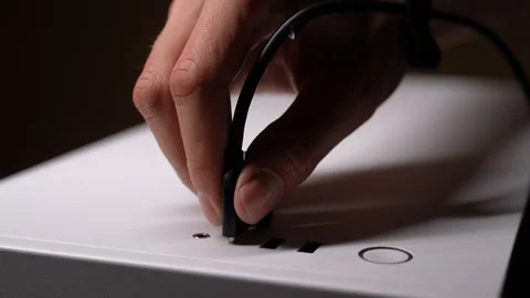 Close-up hands of unrecognizable man plugging type-c cable into white computer Stock Footage 287512990