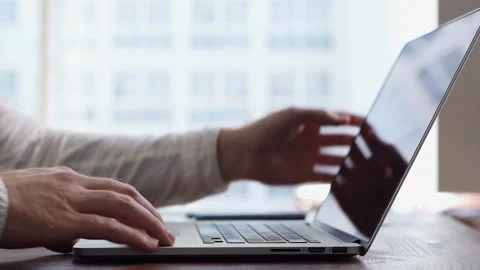 Close-up of hands of unrecognizable man turning off laptop and closing lid. Stock Footage 131072341