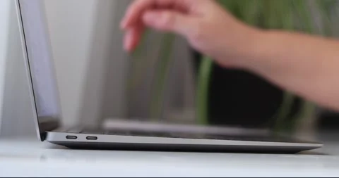 Close-up of hands of unrecognizable man turning off laptop and closing lid of Stock Footage 300364122