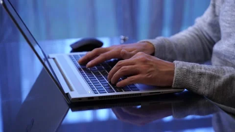 Close-up of hands of unrecognizable man typing on laptop keyboard working home Stock Footage 169478907
