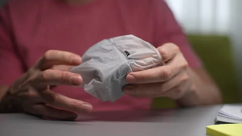 Close-up hands of unrecognizable man unpacking new charger for electronic Stock Footage 297628424