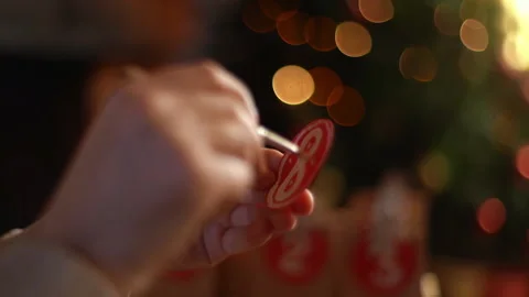 Close-up hands of unrecognizable man writing number on red bag by brush and Video stock 164093335