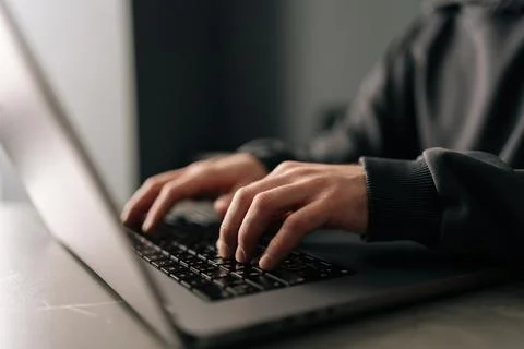Close-up hands of unrecognizable programmer male typing on laptop keyboard Stock Photos
