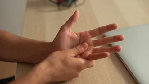 Close-up hands of unrecognizable suffering young man massaging painful palm Stock Footage 160044237