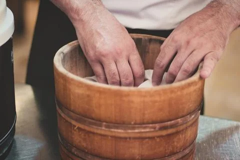 Close-up of hands of a unrecognizable sushi chef cooking rice in a steamer Stock Photos