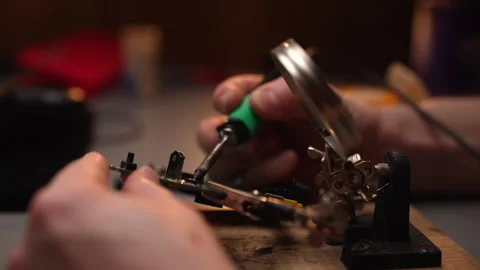 Close-up hands of unrecognizable technician using soldering iron to repair Stock Footage 302566371