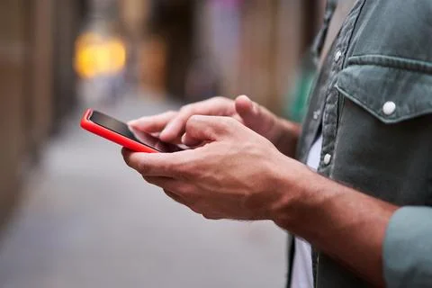 Close up of hands of an unrecognizable white man using phone to be connected one Stock Photos